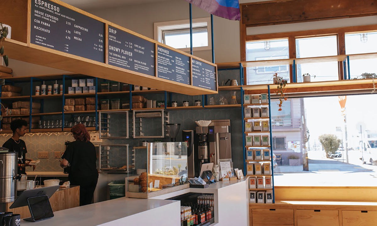 The Lawton Street counter at Andytown Coffee Roasters with menu board and retail shelves